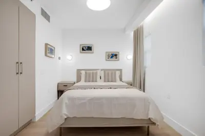a white bedroom with a bed and a white wall at Vonder Miami Beach - Unit 17 in Miami Beach