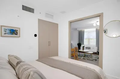 a white bedroom with a bed and a dining room at Vonder Miami Beach - Unit 20 in Miami Beach