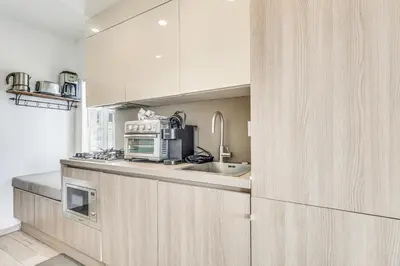 a kitchen with a microwave and a sink at Cozy Miami Beach Apartment Less Than 1 Mi to Ocean! in Miami Beach