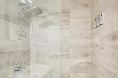 a bathroom with a shower with a glass door at Cozy Miami Beach Apartment Less Than 1 Mi to Ocean! in Miami Beach