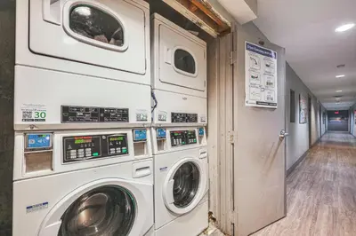 a laundry room with two washer and dryer machines at Cozy Miami Beach Apartment Less Than 1 Mi to Ocean! in Miami Beach