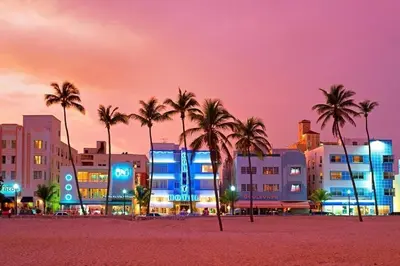 a city at night with palm trees and buildings at Miami Beach Home, 7 guests, Steps from the beach in Miami Beach