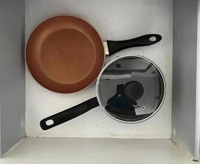 a pot and a frying pan in a box at Walk to the beach, Studio, Pool AND FREE Parking in Hallandale Beach
