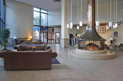 a lobby with couches and a fireplace in a building at Walk to the beach, Studio, Pool AND FREE Parking in Hallandale Beach