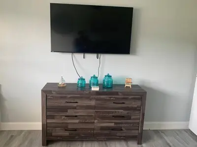 a wooden dresser with a television on top of it at Walk to the beach, Studio, Pool AND FREE Parking in Hallandale Beach