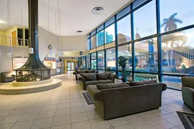 a lobby with couches and a fireplace in a building at Walk to the beach, Studio, Pool AND FREE Parking in Hallandale Beach