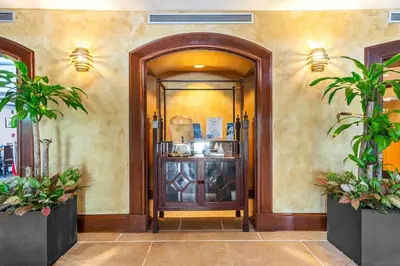 an entrance to a building with a wooden door at The Palms Coconut Grove 1 bedroom condo includes parking in Miami
