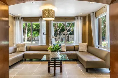 a living room with a couch and a table at The Palms Coconut Grove 1 bedroom condo includes parking in Miami