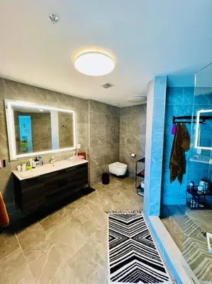 a bathroom with a sink and a toilet and a mirror at North Bay Village - perfect view in Miami Beach