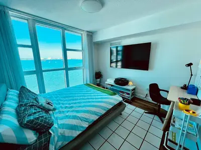 a bedroom with a bed with a view of the ocean at North Bay Village - perfect view in Miami Beach