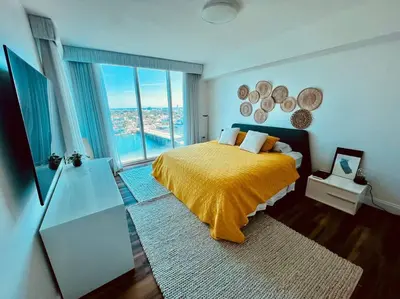 a bedroom with a yellow bed and a large window at North Bay Village - perfect view in Miami Beach