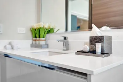 a bathroom counter with a sink and a mirror at Luxury Beach Front Suite with Rooftop Pool in Hollywood