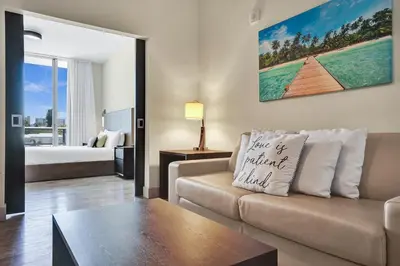 a living room with a couch and a bed at Luxury Beach Front Suite with Rooftop Pool in Hollywood