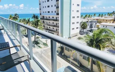 a balcony with a view of the ocean and buildings at Luxury Beach Front Suite with Rooftop Pool in Hollywood