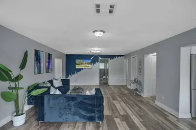 a living room with a blue couch in a room at Luxury Miami Retreat in North Miami