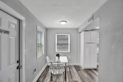 a dining room with a table and a chair at Luxury Miami Retreat in North Miami