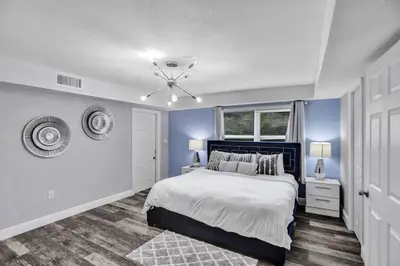 a bedroom with a bed and a blue wall at Luxury Miami Retreat in North Miami