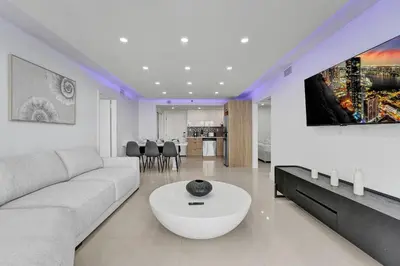 a living room with a white couch and a table at Stunning Ocean View Beach Retreat 1205 in Miami Beach