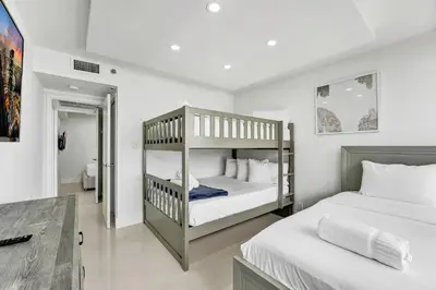 a bedroom with two bunk beds and a bathroom at Stunning Ocean View Beach Retreat 1205 in Miami Beach