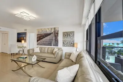 a living room with a couch and a table at Cozy Ocean View Condo Beach Service 617 in Miami Beach
