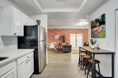 a kitchen with a black refrigerator and a table at Beautiful Home in Maimi in Miami