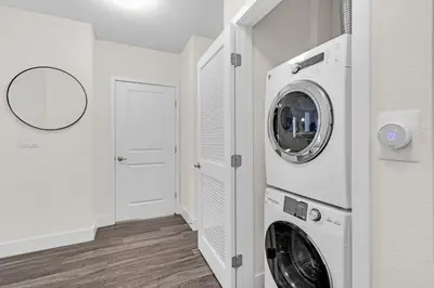a white laundry room with a washer and dryer at Bright and Airy 2 Bed on Biscayne Blvd with Free Park in Miami