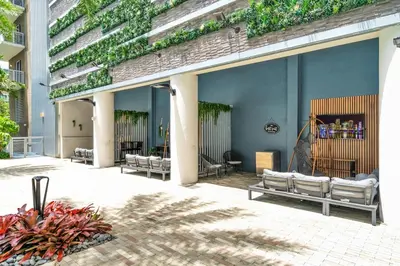 a patio with a group of benches on a building at Bright and Airy 2 Bed on Biscayne Blvd with Free Park in Miami
