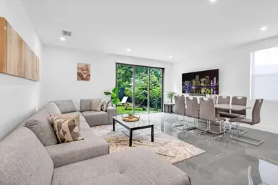 a living room with a couch and a table at Paraiso House Pool 10 Ppl 6 mins Coconut Grove in Miami