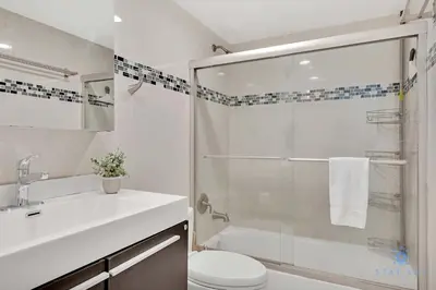a bathroom with a shower and a toilet and a sink at Beautiful apartment with pool and gym in Hollywood