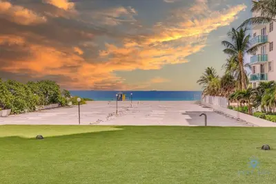 a large parking lot with palm trees and the ocean at Beautiful apartment with pool and gym in Hollywood