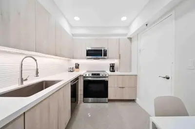 a kitchen with a sink and a stove at Luxe Hollywood Beachfront Condo in Hollywood