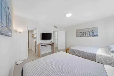 a hotel room with two beds and a television at Luxe Hollywood Beachfront Condo in Hollywood