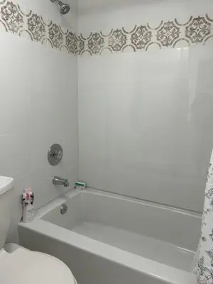 a white bathroom with a tub and a toilet at Beautiful apartment with very elegant colonial decoration in Tamiami