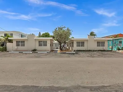 an empty parking lot in front of a house at Coastal Escape, Hollywood Beach Proximity in Hollywood