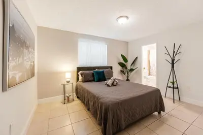 a bedroom with a bed with a stuffed animal on it at Stylish 3 Bedroom Miami Retreat Close Brickell in Miami