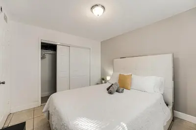 a white bedroom with a large white bed with pillows at Stylish 3 Bedroom Miami Retreat Close Brickell in Miami