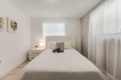 a bedroom with a bed with a teddy bear on it at Stylish 3 Bedroom Miami Retreat Close Brickell in Miami