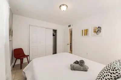 a bedroom with a white bed with towels on it at Stylish 3 Bedroom Miami Retreat Close Brickell in Miami