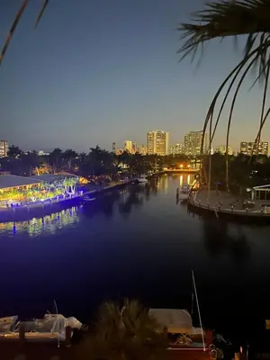a river with boats docked in a city at night at Beautiful Water View Golden Isles in Hallandale Beach
