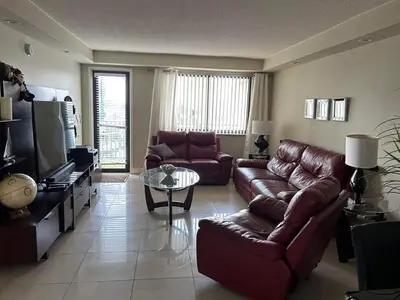 a living room with a couch and a table at Beautiful Water View Golden Isles in Hallandale Beach