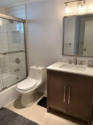 a bathroom with a toilet and a sink and a shower at Beautiful Water View Golden Isles in Hallandale Beach