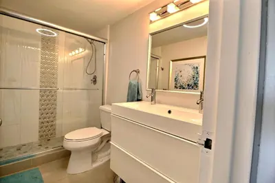 a bathroom with a toilet and a sink and a shower at Golden Isles # 509 in Hallandale Beach