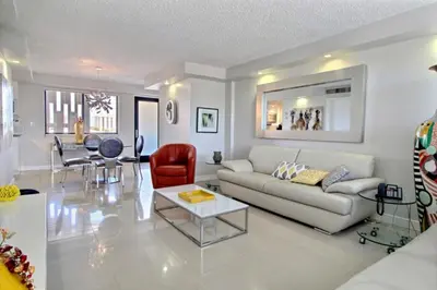 a living room with a couch and a table at Golden Isles # 509 in Hallandale Beach