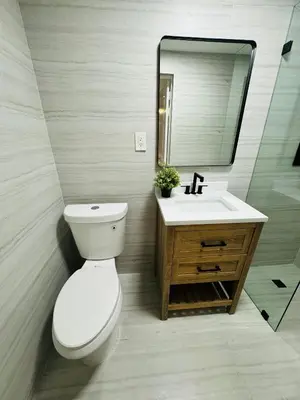 a bathroom with a toilet and a sink and a mirror at La Casita in Miami