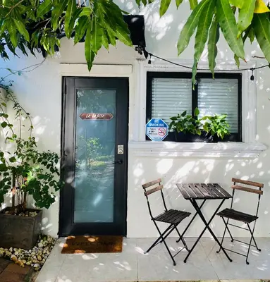 two chairs and a table in front of a door at La Casita in Miami