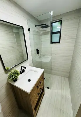 a bathroom with a sink and a glass shower at La Casita in Miami