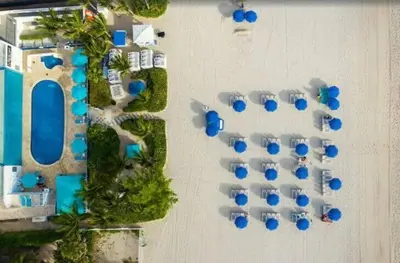 an overhead view of a resort with blue umbrellas at Amazing Apartment Oceanview Beautiful Amenities in Sunny Isles Beach