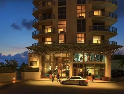 a car parked in front of a building at Amazing Apartment Oceanview Beautiful Amenities in Sunny Isles Beach
