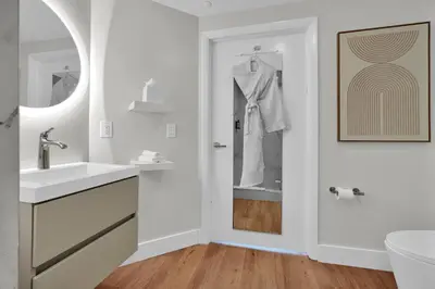 a white bathroom with a sink and a mirror at 2bedroom City Ocean Treasure in Miami