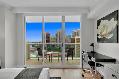 a bedroom with a view of a table and chairs at Find Tranquility in the Grove in Miami